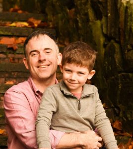 Ben Sexton, a caucasian Man holding his son